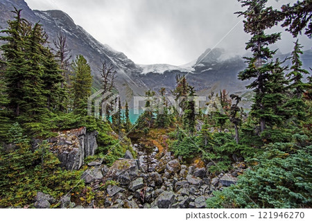 Hiking view near Mt Garibaldi with turquoise lake and dramatic clouds in the mountains 121946270