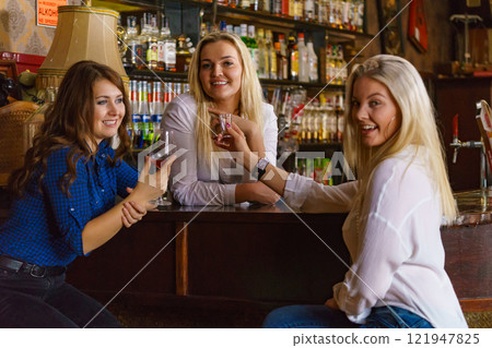 Girls in pub club gossiping and talking Girls in pub club gossiping and talking 121947825