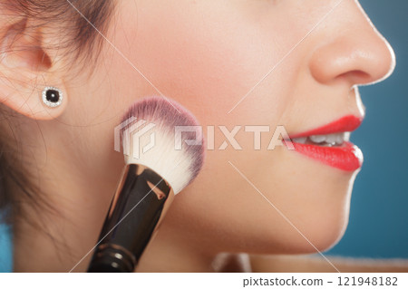 woman applying rouge blush makeup woman applying rouge blush makeup 121948182