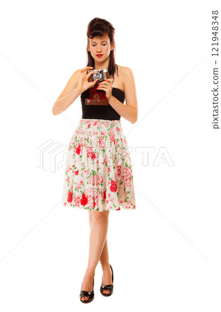 Teen girl with old camera 121948348