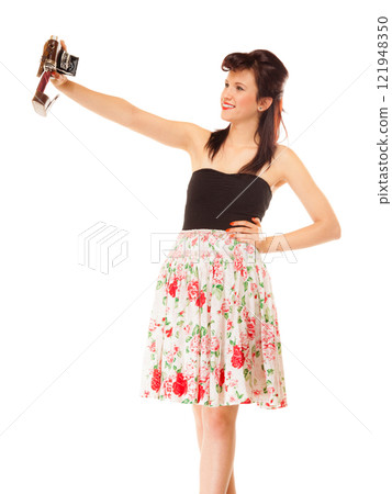 Girl taking self portrait from vintage camera 121948350