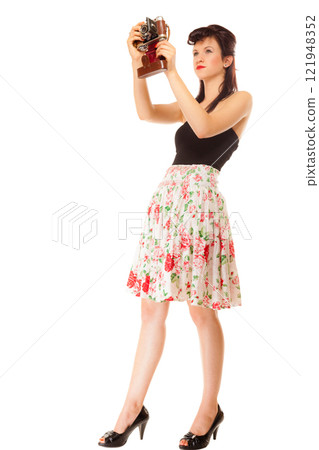 Girl taking self portrait from vintage camera 121948352