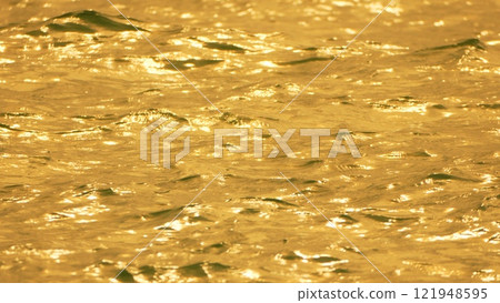 Water, Sunlight, Reflections - Close-up of shimmering water reflecting golden light. Water, Sunlight, Reflections - Close-up of shimmering water reflecting golden light. 121948595