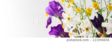 Bouquet of spring flowers, irises and yellow ranunculus with white daffodils Bouquet of spring flowers, irises and yellow ranunculus with white daffodils 121948836