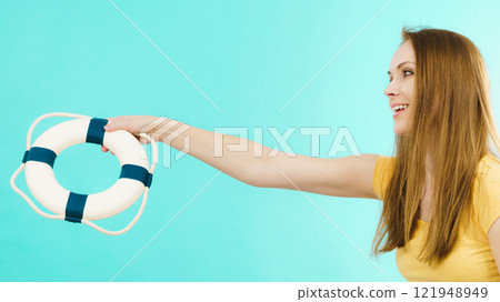 Girl holds life buoy rescue ring 121948949