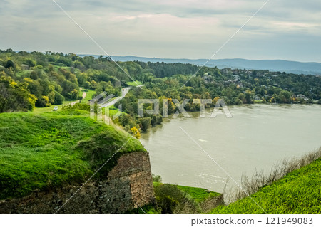 The fortress perched on Petrovaradin Hill watches over the city, while the charming streets and modern buildings of Novi Sad are spread out, creating a perfect blend of history and contemporary life The fortress perched on Petrovaradin Hill watches over the city, while the charming streets and modern buildings of Novi Sad are spread out, creating a perfect blend of history and contemporary life 121949083