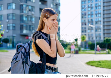 Sad unhappy teenage college student girl with backpack, outdoor, city background Sad unhappy teenage college student girl with backpack, outdoor, city background 121949277