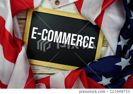 E-Commerce text messege with USA flag on wooden background E-Commerce text messege with USA flag on wooden background 121949733