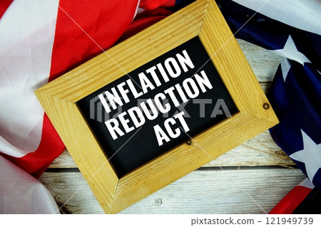 Inflation Reduction Act text messege with USA flag on wooden background 121949739
