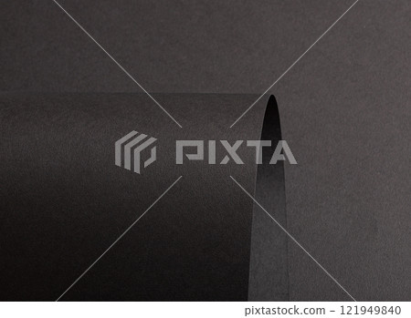 Jet black paper background with a matte, grainy texture and subtle gradient. Dark tones create a 121949840