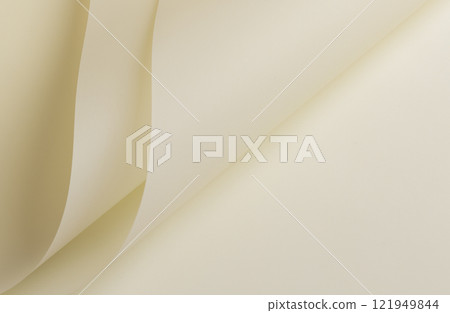 Ivory cream paper background with layered, folded edges and a smooth, matte texture. Light beige 121949844
