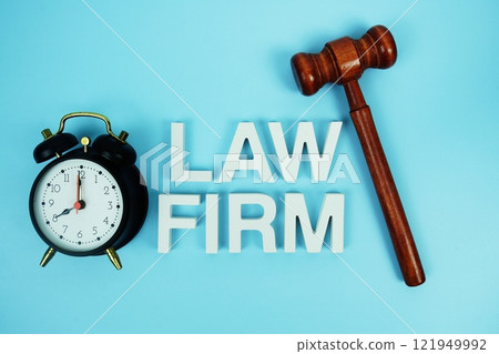 Law Firm alphabet letters with wooden judge gavel and alarm clock on blue background Law Firm alphabet letters with wooden judge gavel and alarm clock on blue background 121949992