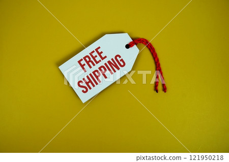 Free Shipping on price tag with wooden clothes hanger top view on yellow background 121950218