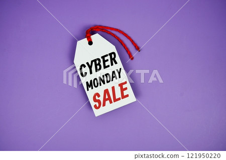 Cyber Monday Sale on price tag with wooden clothes hanger top view on purple background 121950220