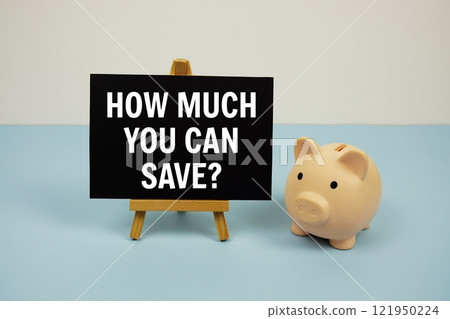 How much you can save? text quotes text on paper card and easel standing with piggy saving on blue background 121950224