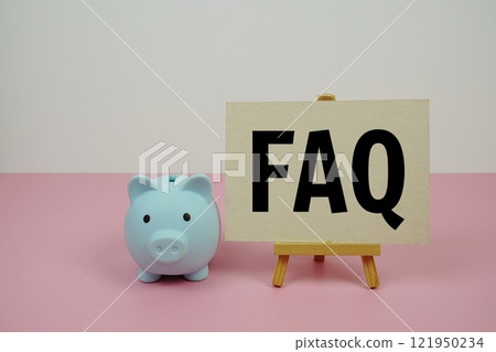 FAQ text on paper card and easel standing with piggy saving on pink background FAQ text on paper card and easel standing with piggy saving on pink background 121950234