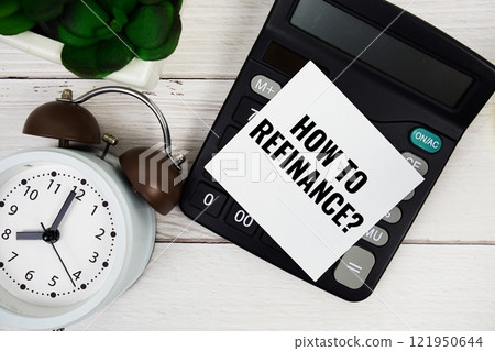 How to refinance? text message with calculate and alarm clock top view on wooden background How to refinance? text message with calculate and alarm clock top view on wooden background 121950644