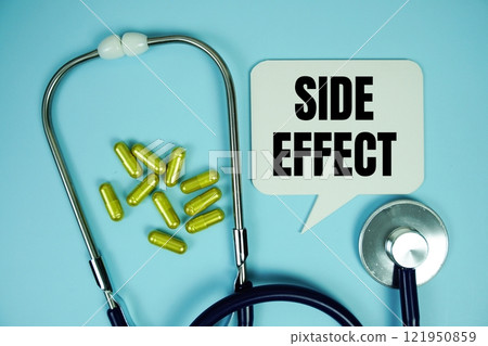 Side Effect text with stethoscope and capsule medicine on blue background, Healthy and wellness concept 121950859
