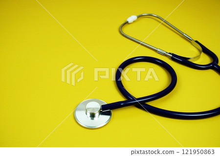 Stethoscope medical equipment isolated on yellow background 121950863