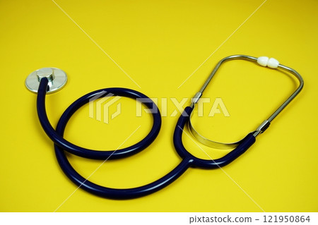 Stethoscope medical equipment isolated on yellow background 121950864