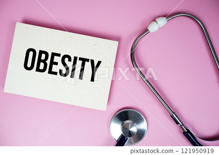 Obesity text with stethoscope on pink background, Healthy and wellness concept Obesity text with stethoscope on pink background, Healthy and wellness concept 121950919