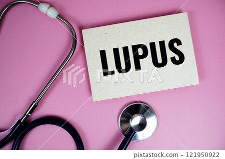 Lupus text with stethoscope on pink background, Healthy and wellness concept 121950922