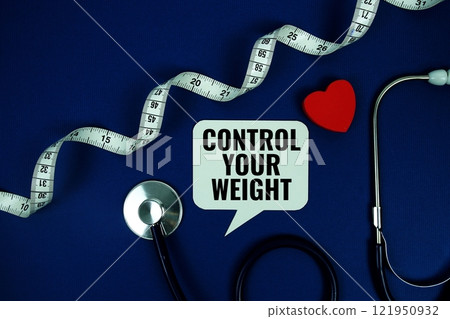 Control Your Weight text with stethoscope and measuring tape top view on blue background Control Your Weight text with stethoscope and measuring tape top view on blue background 121950932