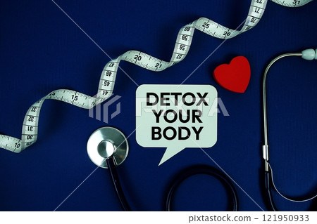 Detox Your Body text on speech bubble with Red heart , measure tape and stethoscope on navy blue background, Healthy concept 121950933