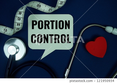 Portion Control text on speech bubble with measure tape and stethoscope on navy blue background, Healthy concept Portion Control text on speech bubble with measure tape and stethoscope on navy blue background, Healthy concept 121950934