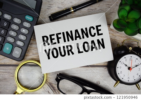 Refinance your loan text with calculator, magnifying glass and alarm clock on wooden background 121950946