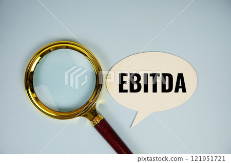 EBITDA text on speech bubble with magnifying glass top 121951721