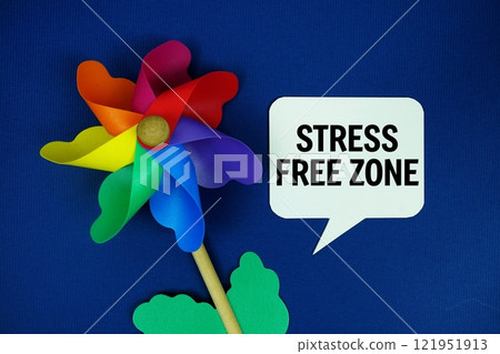 Stress Free Zone text motivational and inspiration quote with colorful pinwheel top view on blue background Stress Free Zone text motivational and inspiration quote with colorful pinwheel top view on blue background 121951913