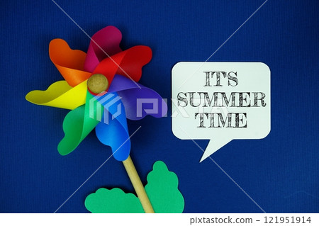 It's Summer Time text motivational and inspiration quote with colorful pinwheel top view on blue background It's Summer Time text motivational and inspiration quote with colorful pinwheel top view on blue background 121951914