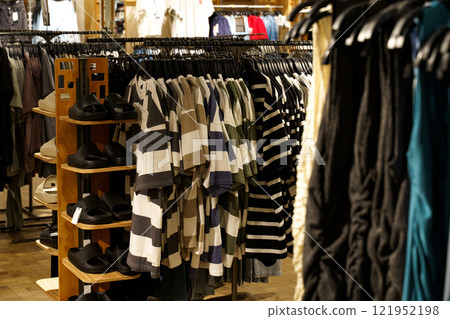 Colorful clothing display in a trendy boutique during a bustling afternoon Colorful clothing display in a trendy boutique during a bustling afternoon 121952198