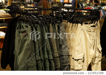 Cargo shorts display in a colorful retail setting at a busy store 121952199
