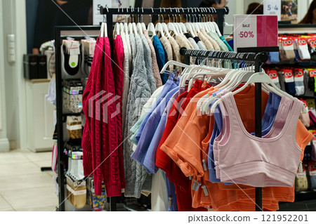 Colorful display of stylish clothing on sale in a trendy boutique Colorful display of stylish clothing on sale in a trendy boutique 121952201