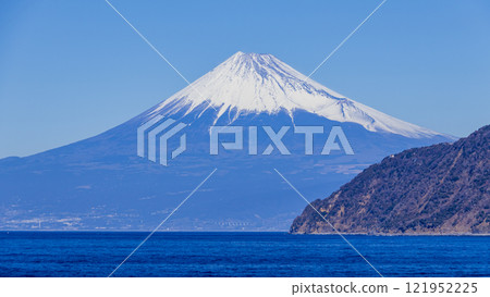 Snow-capped Mount Fuji seen from across the sea 121952225
