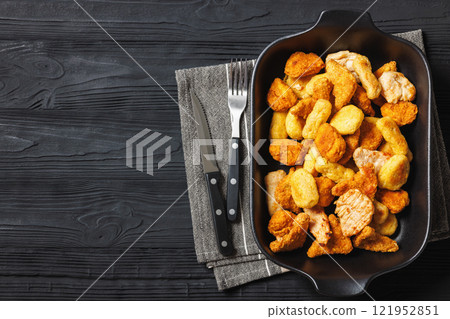 fried chunks, bites, tenders, nuggets on a dish 121952851