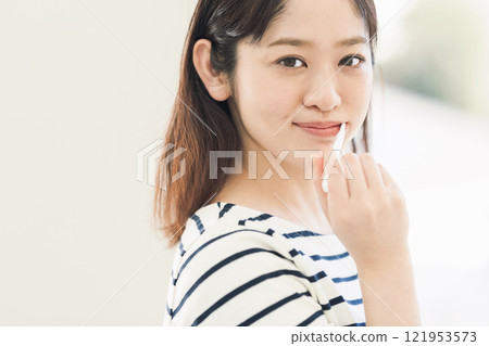 A young woman brushing her teeth A young woman brushing her teeth 121953573
