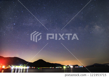 Spring starry scenery in Setouchi: The Milky Way and Cygnus in the sky above a fishing port 121953715