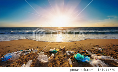 A beach covered in plastic waste and toxic debris, symbolizing the severe impact of ocean pollution on marine life and the urgent need for global efforts in reducing plastic use A beach covered in plastic waste and toxic debris, symbolizing the severe impact of ocean pollution on marine life and the urgent need for global efforts in reducing plastic use 121954770