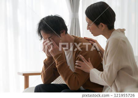 A depressed husband and an encouraging wife 121955726