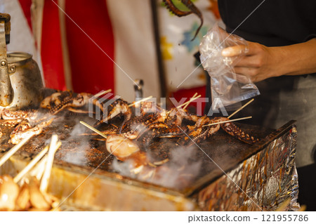 Festival: Grilled squid stall cooking scene 121955786
