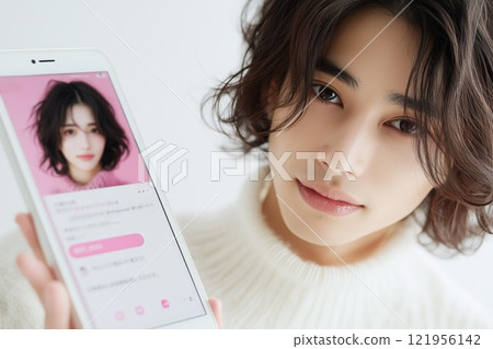 A young man searching for a marriage partner using an AI matching app on his smartphone A young man searching for a marriage partner using an AI matching app on his smartphone 121956142