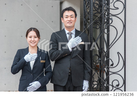 Concierge, hotel man, hotelier, wedding planner men and women in suits working at the hotel Concierge, hotel man, hotelier, wedding planner men and women in suits working at the hotel 121956236