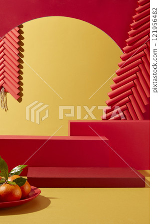 A product advertisement photo with a Chinese New Year theme. A platter of tangerines, a hanging firecracker ornament, decorated around some empty red podiums, on a red and yellow background. 121956482