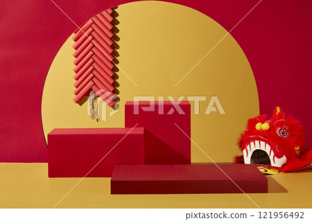 An image of the Chinese New Year on a background of red and yellow. Close-up of empty red rectangular platforms for showcasing products, adorned with a dancing lion head and a firework string. 121956492