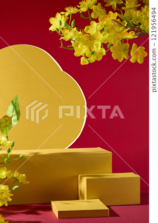 A Chinese New Year concept. Front angle of some golden podium with empty space for display product. Decor with a crimson wall with a flower-shaped hole and yellow apricot blossoms. A Chinese New Year concept. Front angle of some golden podium with empty space for display product. Decor with a crimson wall with a flower-shaped hole and yellow apricot blossoms. 121956494