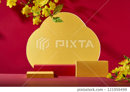 A Chinese New Year concept for a product advertisement. In front of several empty red and yellow product display podiums, adorned with some yellow apricot bloom, on a crimson and golden background. 121956499