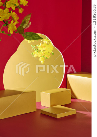 Some empty gold rectangular platforms are used in a minimalist product display with a Lunar New Year motif. A flower-shaped cutout in a red wall shows a yellow apricot bloom with a gold backdrop. 121956519